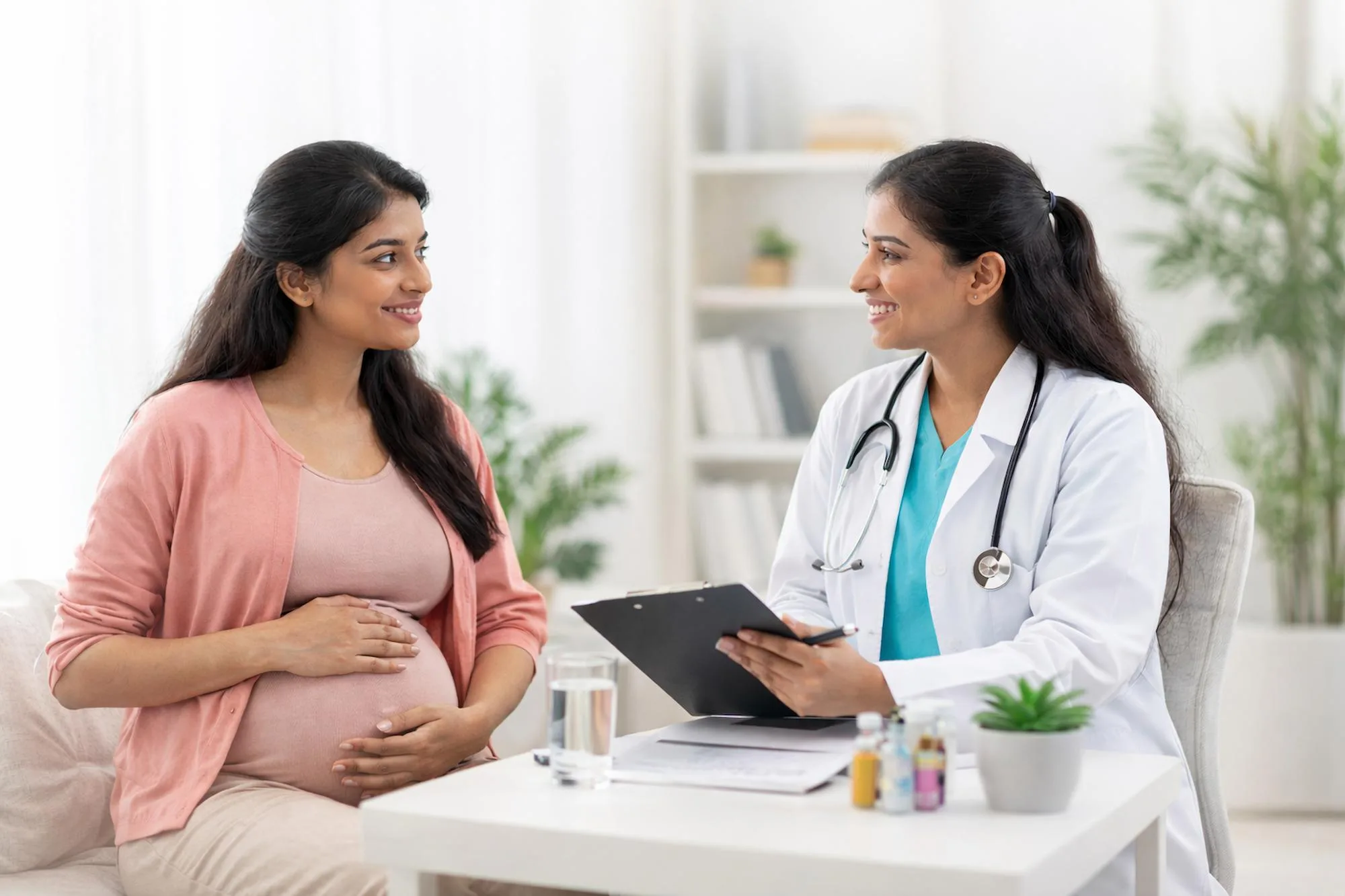 Doctor discussing pregnancy care with an expectant mother
